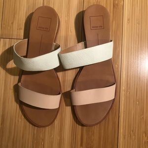 White and light pink slide sandals.